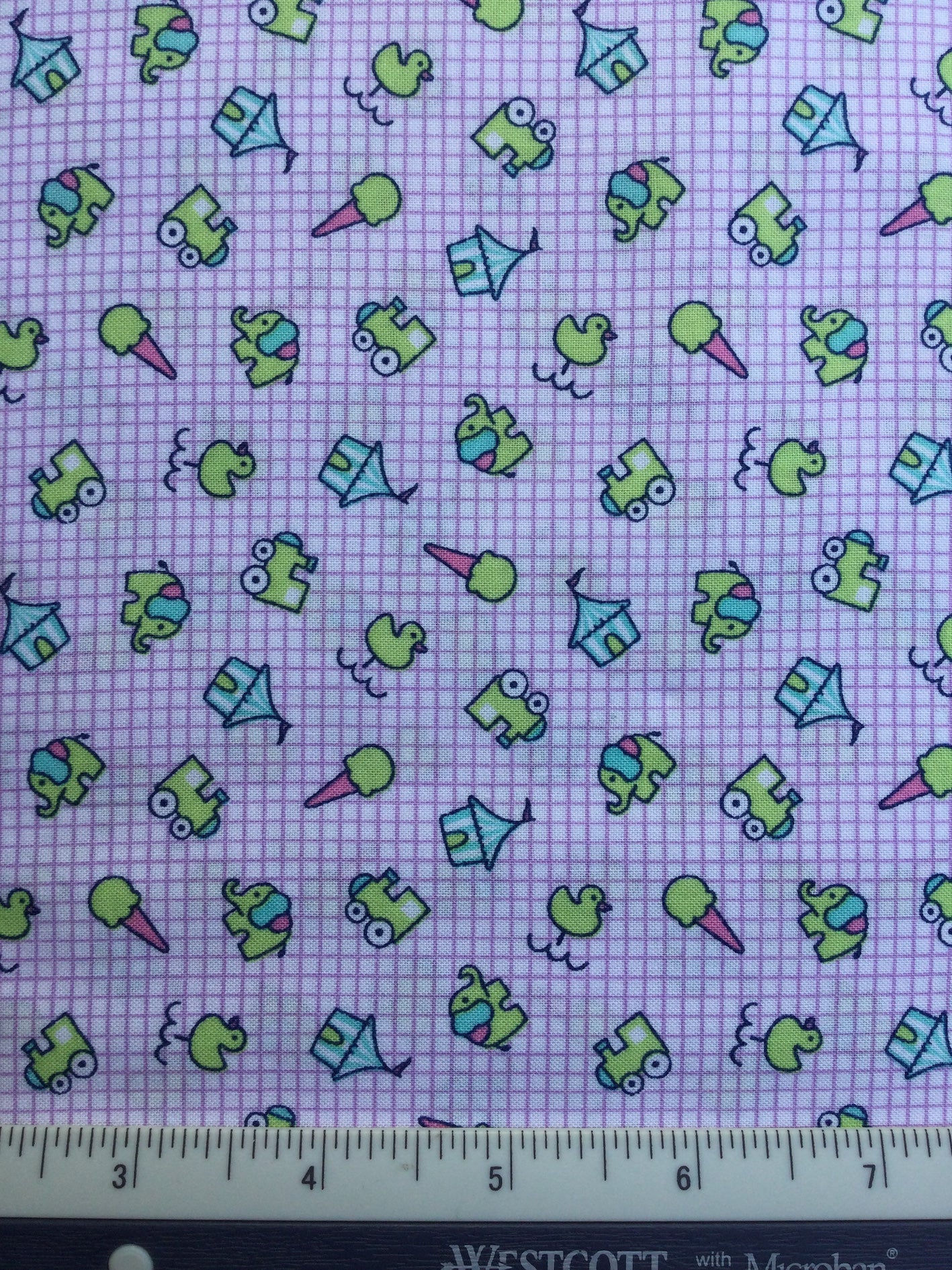 Fun Fair - FS026 - White & Mauve checked background with bright little motifs.