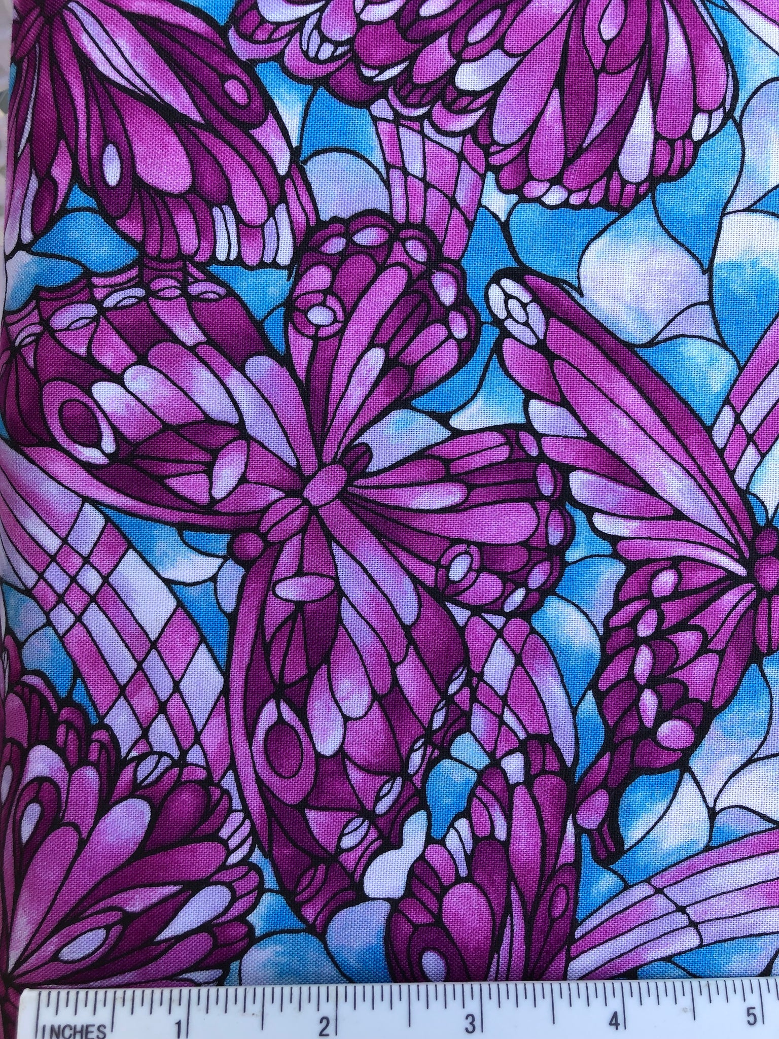 Light Fantastic - FS192 - Blue background with stylised butterflies in shades of Bright Pink